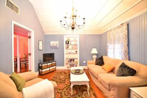 a living room with a couch and a table at Historic Apartment in the Heart of Christiansted in Christiansted