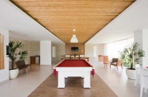 a pool table in the middle of a room at Condominio Reserva da Mata - Riviera de São Lourenço in Riviera de São Lourenço