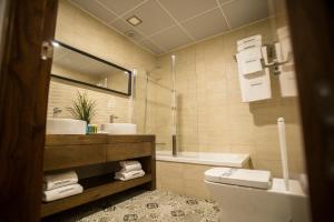 a bathroom with a toilet and a sink and a mirror at MD Casa Palacio Muñoz Chaves Siglo XVIII in Cáceres +32 photos