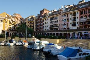 a group of boats docked in a marina with buildings at ApartUP Saplaya Harbour in Alboraya