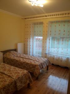 a bedroom with two beds and a window at Apartments Natalija in Sigulda