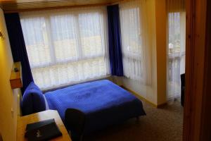 Lova arba lovos apgyvendinimo įstaigoje Hotel Alpha