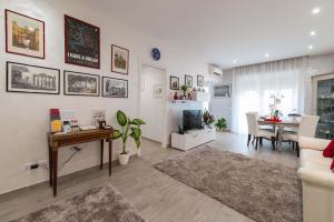 a living room with a television and a dining room at M&M House in Rome