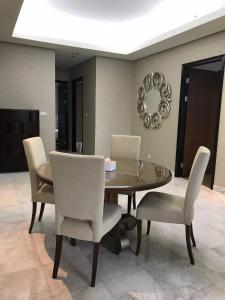 a dining room with a table and chairs at The Peak Residence at Sudirman - 3 BR Exclusive Private Apartment in Jakarta