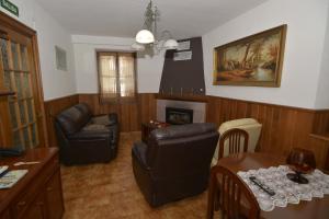 sala de estar con muebles de cuero y chimenea en Casa Rural Teodoro Barrio, en Aribe