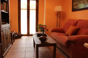 a living room with a couch and a coffee table at Casa Rural El Pinar in Acebedo