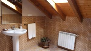 a bathroom with a sink and a mirror and a toilet at Casa Rural El Pinar in Acebedo +50 photos