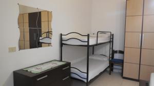 a room with a bunk bed and a mirror at Blu Mariner in Vada