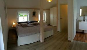 a bedroom with a bed and a sink in it at La Vie in Kappeln