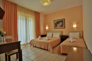 Posteľ alebo postele v izbe v ubytovaní Hotel Ilion