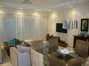 a living room with a couch and a table at Cap Cana Luxurious Marina Condo in Punta Cana