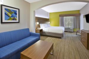 a hotel room with a bed and a couch at Holiday Inn Express Hotel & Suites Cincinnati Northeast-Milford, an IHG Hotel in Milford