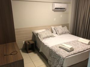 a small bedroom with a bed and a tv at Serra Madre in Rio Quente