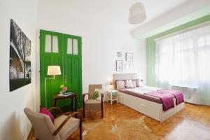 a bedroom with a bed and a green door at Green Door Family Apartment in Budapest