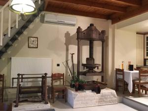 a living room with an old fashioned stove in a room at Old Olive House in Kouroukláta