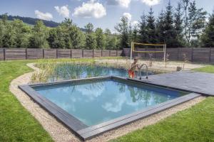 a child playing in a pool in a yard at N°75- Na Uboczu in Krynica Zdrój