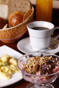 a table with a bowl of food and a cup of coffee at Morenica del Rosario in Cuenca