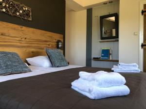 a hotel room with a bed with towels on it at Hotel de Plank - alle kamers met airconditioning in Noorbeek