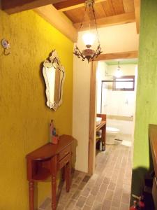 a bathroom with a table and a mirror on the wall at Sobrado Estilo Alemão in Canela +47 photos