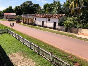 a street with two people walking down a road at Hotel Araruna in Soure