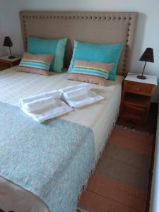 a large bed with two trays on top of it at Casa dos Teares in Aldeia das Dez