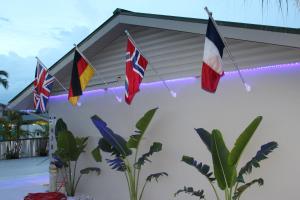 a group of flags hanging from a house at Latitude 26 Waterfront Boutique Resort - Bonita Springs in Bonita Springs