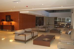 a large living room with couches and tables at Hotel de la Cité in Rosario