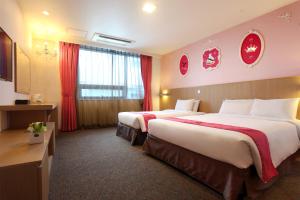 Postel nebo postele na pokoji v ubytování Hotel Skypark Jeju 1