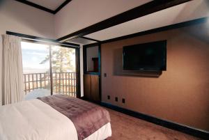 a bedroom with a bed and a flat screen tv at The Ridge Sierra in Stateline
