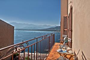 a balcony with a table and a view of the ocean at Mare e vista appartement 3 chambres in Calvi