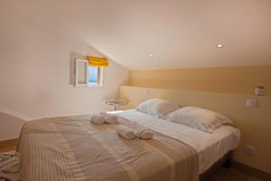 a bedroom with a bed with towels on it at Mare e vista appartement 3 chambres in Calvi