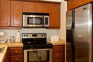 a kitchen with a stove and a microwave at Los Suenos Resort Veranda 5A by Stay in CR in Herradura