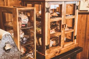 a wooden cabinet filled with lots of food at Arrowhead Mountain Lodge in Cimarron