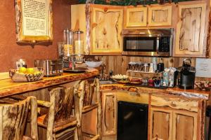 a kitchen with wooden cabinets and a counter top at Arrowhead Mountain Lodge in Cimarron