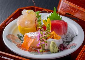 a plate of different types of food on a table at Ryoso Uminocho in Ise