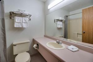 a bathroom with a sink and a toilet and a mirror at Motel 6-Marion, IL in Marion +21 photos