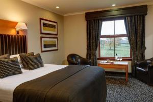 a hotel room with a large bed and a window at Best Western Garfield House Hotel in Chryston +54 photos