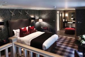a hotel room with a large bed and a bathroom at Best Western Eglinton Arms Hotel in East Kilbride