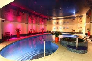 a large swimming pool in a large room at Best Western Heronston Hotel & Spa in Bridgend