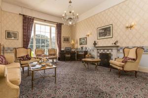 a living room filled with furniture and a fireplace at Best Western Hotel de Havelet in St. Peter Port