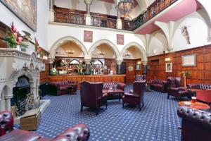 a large room with chairs and a fireplace at Bestwood Lodge Hotel in Nottingham