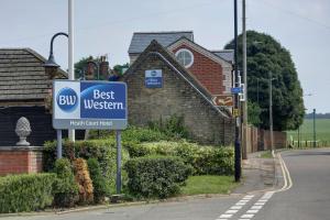 a best western sign in front of a house at Best Western Heath Court Hotel in Newmarket