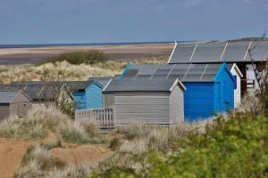 a row of houses with solar panels on the beach at Old Hunstanton Le Strange Arms Hotel in Hunstanton