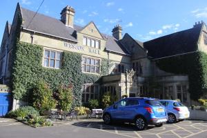a blue car parked in front of a building at Weston Hall Hotel Sure Hotel Collection by Best Western in Bulkington
