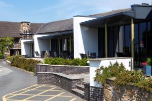 a house with black and white windows and a driveway at Lancashire Manor Hotel, BW Signature Collection in Skelmersdale