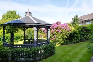 a blue gazebo in a yard with flowers at Lancashire Manor Hotel, BW Signature Collection in Skelmersdale