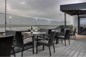 a table and chairs on a patio with a view of the ocean at Best Western Hotel Hatfield in Lowestoft
