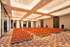 an empty hall with orange chairs in a building at Grand Hyatt Kochi Bolgatty in Cochin +44 photos