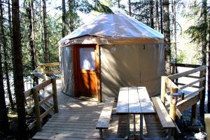 a yurt with a bench on a wooden deck at Riverside Resort in Whistler