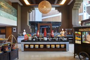 a buffet in a restaurant with food on display at Aston Sentul Lake Resort & Conference Center in Bogor